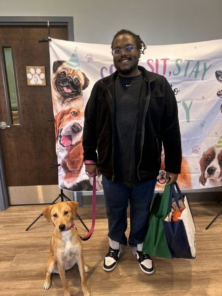 A man with a dog on leash